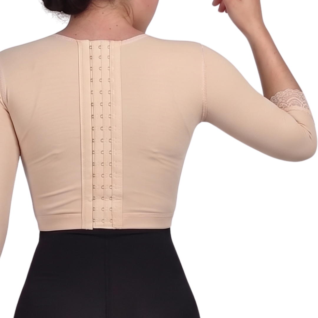 Faja torerita de alta compresión diseñada para recuperación postoperatoria de brazos. Fabricada con Powernet y Spandex, ayuda a reducir la hinchazón y moldear. Cuenta con gafetes para ajuste y encaje decorativo. Ideal para confort y soporte en tu recuperación.